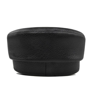 Close-up of black PU leather texture and fine stitching on the octagonal sailor cap