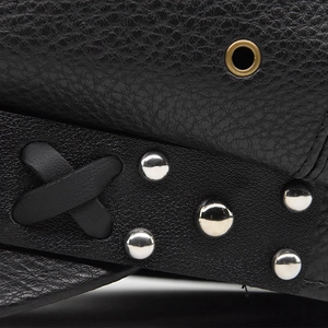 Macro detail of black PU leather texture with metal rivets and eyelets on octagonal cap