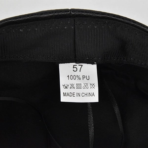 Detail view of the black PU leather beret interior with 57 size label and sweatband