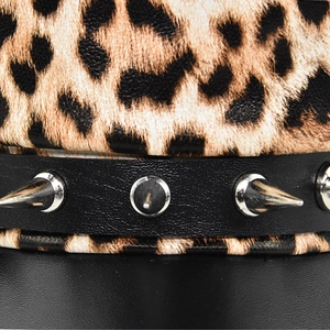 Detailed macro view of leopard print fur with punk style silver metal cone studs on leather