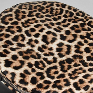 Close-up of leopard print wool fabric texture on a flat top beret with soft faux fur finish