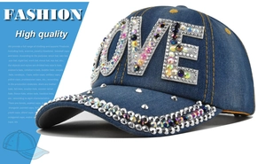 Dettaglio di strass scintillanti sulla scritta LOVE e sulla tesa del cappello di jeans
