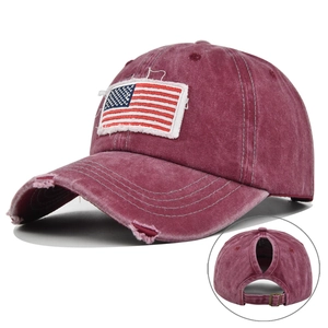 Close-up of distressed wine red ponytail baseball cap with American flag embroidery