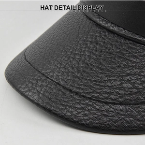 Detail view of the black PU leather brim showing high-quality lychee texture and fine stitching