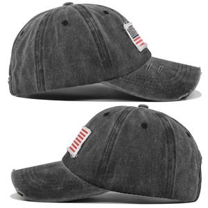 Detail view of washed cotton baseball cap with American flag patch and distressed edges