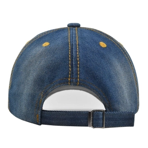 Detail of adjustable metal strap on blue denim baseball cap with yellow contrast stitching