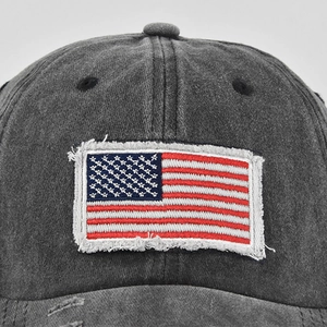 Detail shot of distressed American flag embroidery on washed cotton ponytail baseball cap