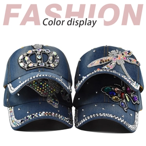 Detail of blue denim baseball caps with rhinestone crown and butterfly patterns