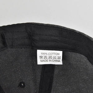 Detail view of cotton ponytail baseball cap interior with wash care label and stitching