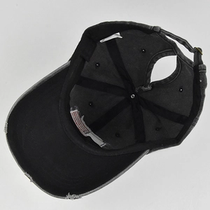Inside view of distressed ponytail baseball cap with American flag label and washed texture