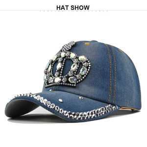 Detail of blue denim baseball cap with rhinestone crown and silver studs on the brim