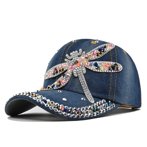 Detail of rhinestone dragonfly on denim baseball cap with crystal embellished brim