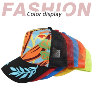 Close-up of trucker hats featuring leaf embroidery on brim and breathable mesh back panels