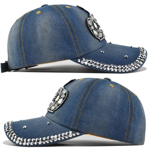 Close-up of washed blue denim baseball cap with sparkling rhinestones and metal studs