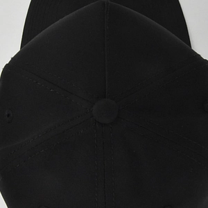 Detailed top view of a six-panel solid black baseball cap showing the crown button and stitching