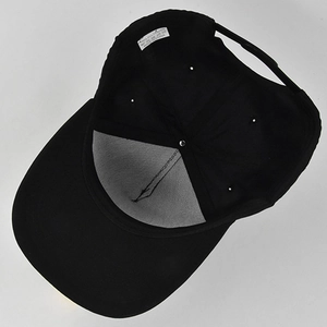 Detail view of the interior construction and 100% polyester fabric lining of black baseball cap