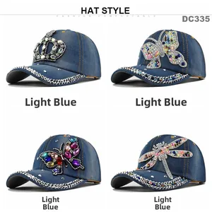 Detail view of light blue denim baseball caps featuring rhinestone crown and butterfly designs
