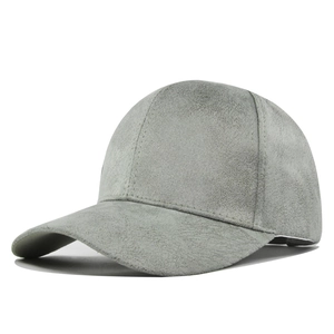 Macro shot of the grey faux suede texture and seamless stitching on a baseball cap