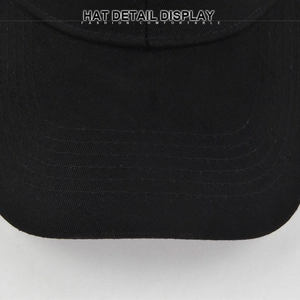 Close-up detail of high-density stitching on the brim of a black cotton baseball cap