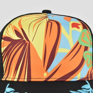 Detailed close-up of tropical print design and leaf embroidery on the black mesh baseball cap