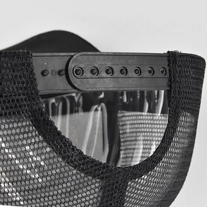 Detail of adjustable snapback closure and breathable mesh texture on the black baseball cap