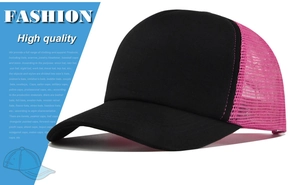 Detail showing breathable mesh back and contrast pink panel of the black trucker hat