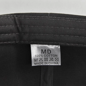 Close-up of 100% cotton material label and stitching detail on the baseball cap