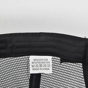 Macro view of interior mesh fabric and 50% cotton care label for baseball cap