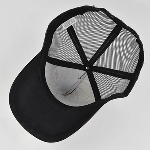 Detail view of cotton-polyester blend trucker hat inner mesh and wash care label