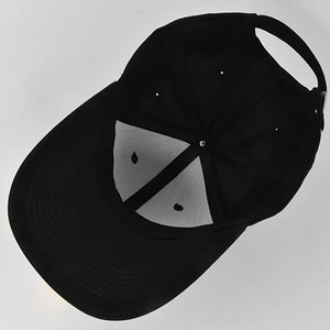Internal view of a black cotton baseball cap showing 6-panel structure and adjustable strap