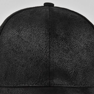 Macro shot of black baseball cap stitching and suede-like textured fabric details