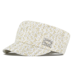 Detailed close-up of white floral cadet cap featuring a crystal square buckle ornament