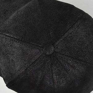 Top view of a black suede baseball cap showing stitching detail and center button