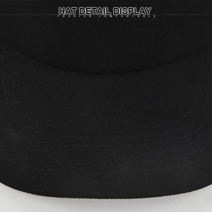 Detail view of the black cotton twill baseball cap showing reinforced brim stitching