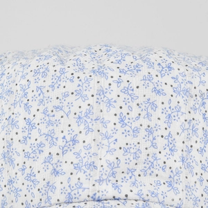 Detailed macro view showing the floral cotton texture and pattern of the flat top cap