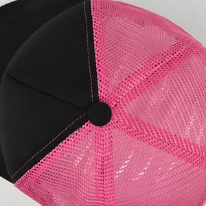 Detail view of the trucker hat showing pink breathable mesh and black top stitching detail