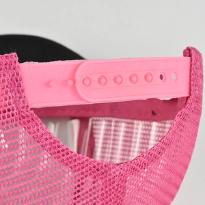 Detail view of the pink adjustable plastic snapback strap and breathable mesh of the trucker hat