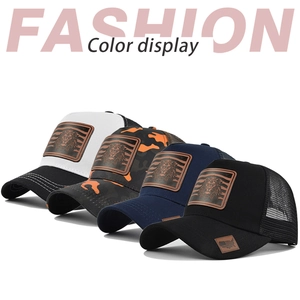 Collection of lion patch mesh trucker hats in black, navy, and orange camo styles