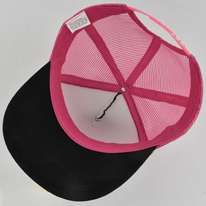 Detailed interior of mesh trucker cap showing pink adjustable strap and material tag