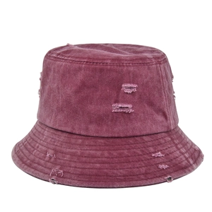 Distressed washed cotton bucket hat in burgundy with frayed edges and ripped details