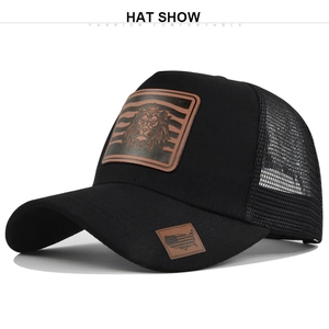 Detail showing lion patch on black trucker hat with breathable mesh and bill patch