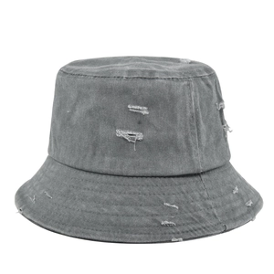 Detail shot of distressed grey washed denim bucket hat with ripped holes and frayed edges
