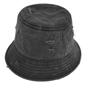 Close-up of distressed denim bucket hat featuring vintage washed fabric and ripped hole detail