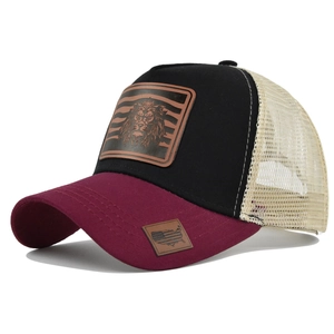 Detail of lion patch trucker hat featuring breathable mesh and American flag brim label
