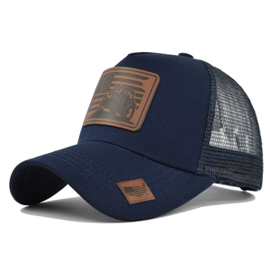 Detail of navy trucker hat with leather flag patch and breathable mesh back