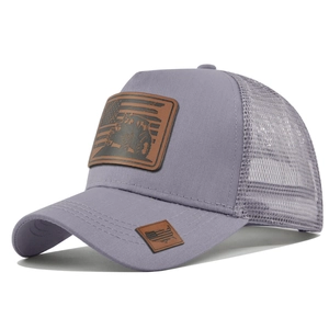 Detail of the tractor leather patch on a grey-purple breathable mesh trucker hat