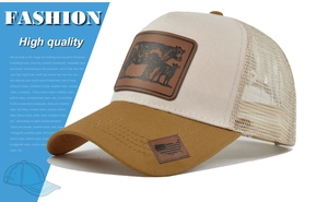 Close-up of trucker hat featuring embossed cow leather patch and mesh back detail