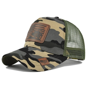 Detail of camouflage trucker hat showing mesh panels and American flag leather patch