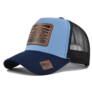 Close-up of trucker hat with embroidered lion leather patch and breathable mesh back