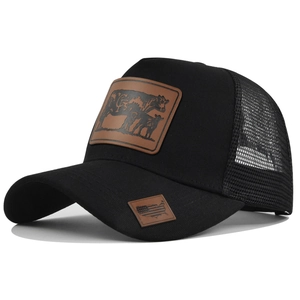 Detail of black trucker hat with brown leather cow patch and breathable mesh back
